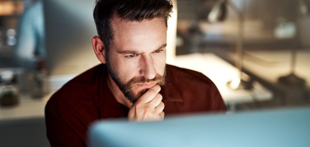 Man researches on SecureTrust about web risk monitoring.